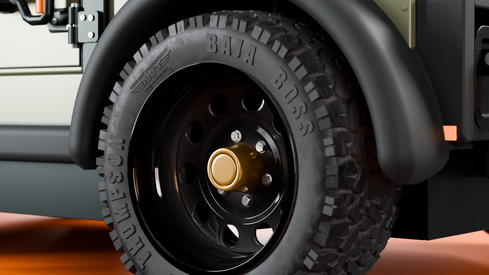 Close-up of the black wheel, gold hub cap and all-terrain tyre